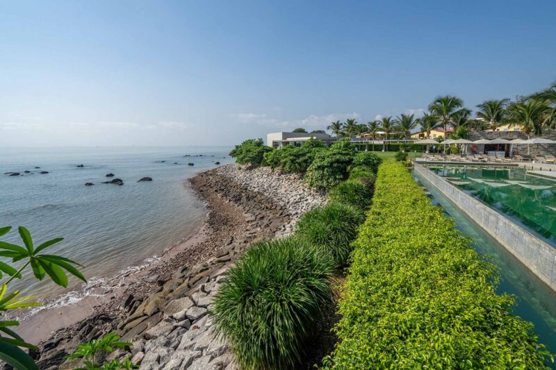 une piscine à côté d' une plage avec une vue sur l'océan