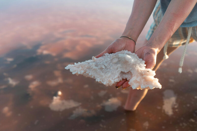 a person holding a piece of salt in their hands