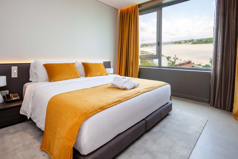 a hotel room with a large bed and a large window