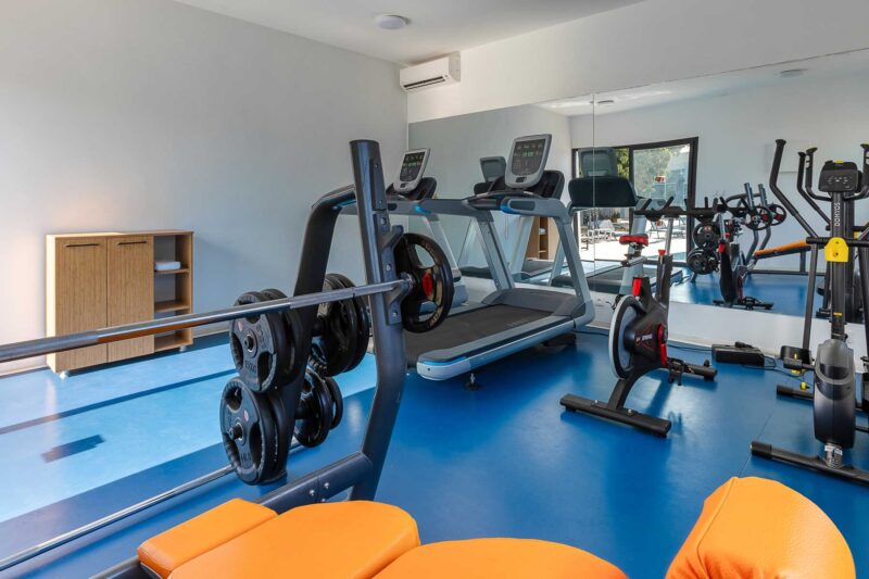 a gym with a treadmill and an exercise bike