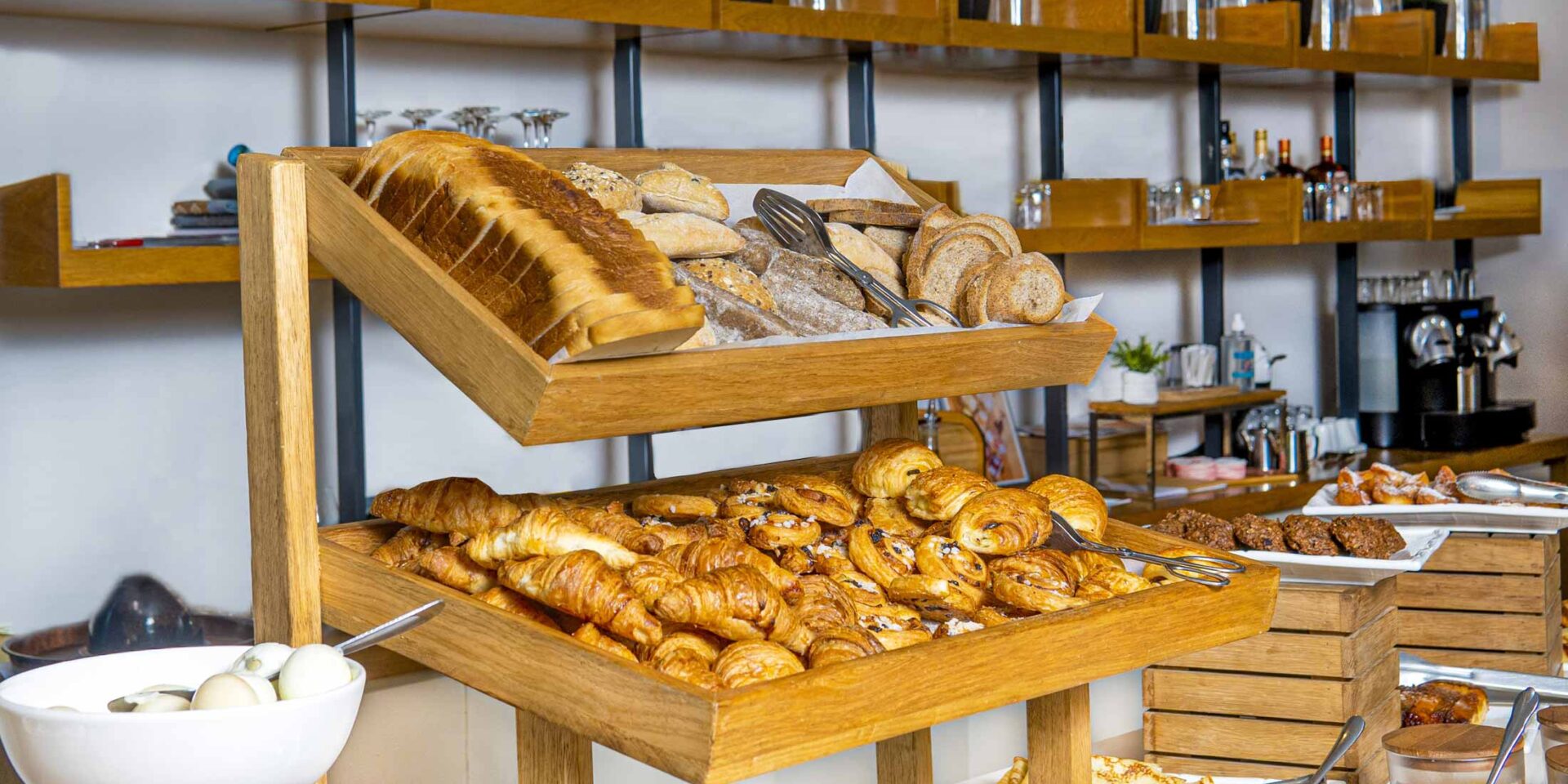 a variety of breads and pastries are on display at a buffet