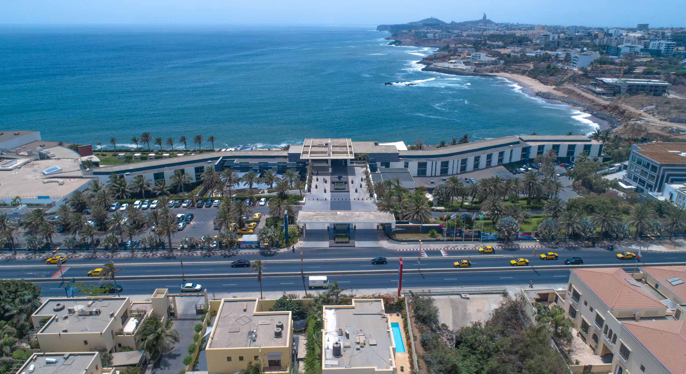 an aerial view of a hotel near the ocean