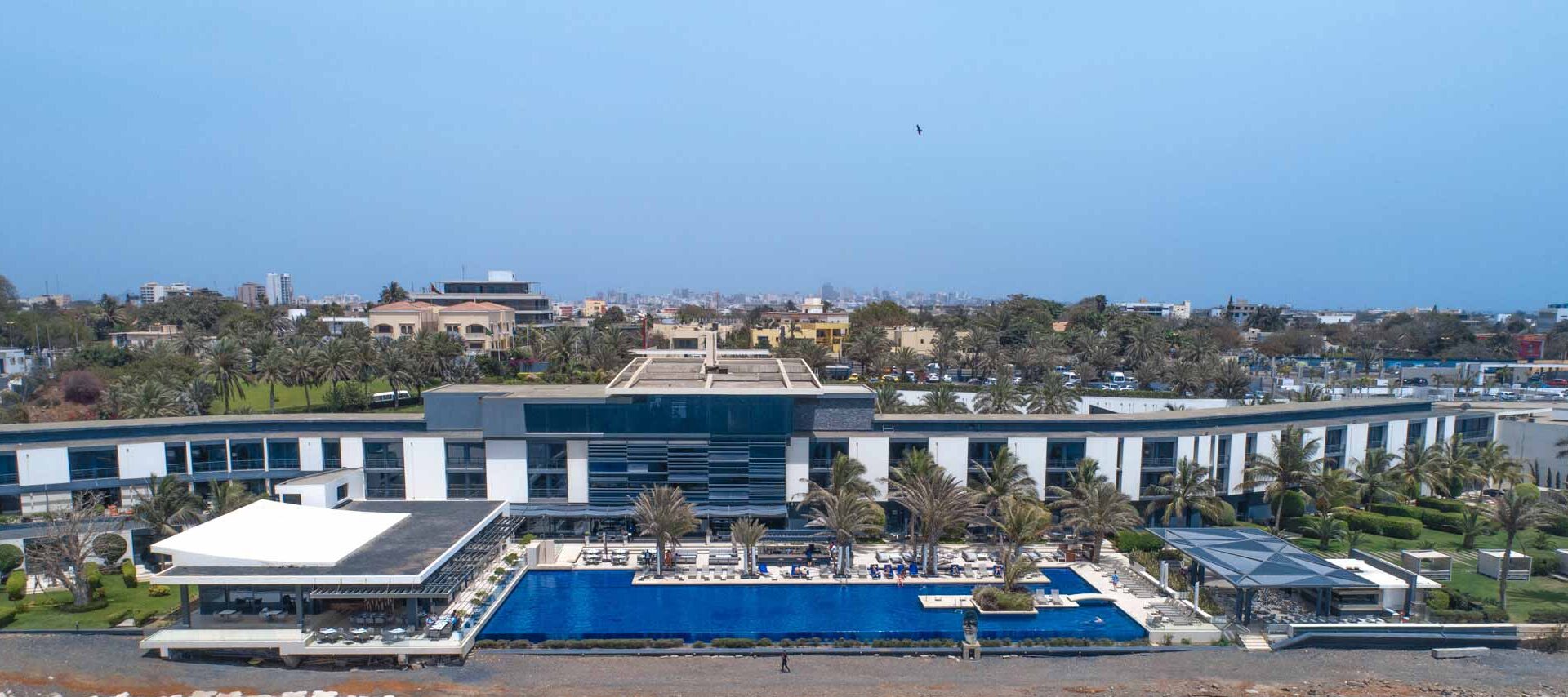 a large building with a large pool in front of it