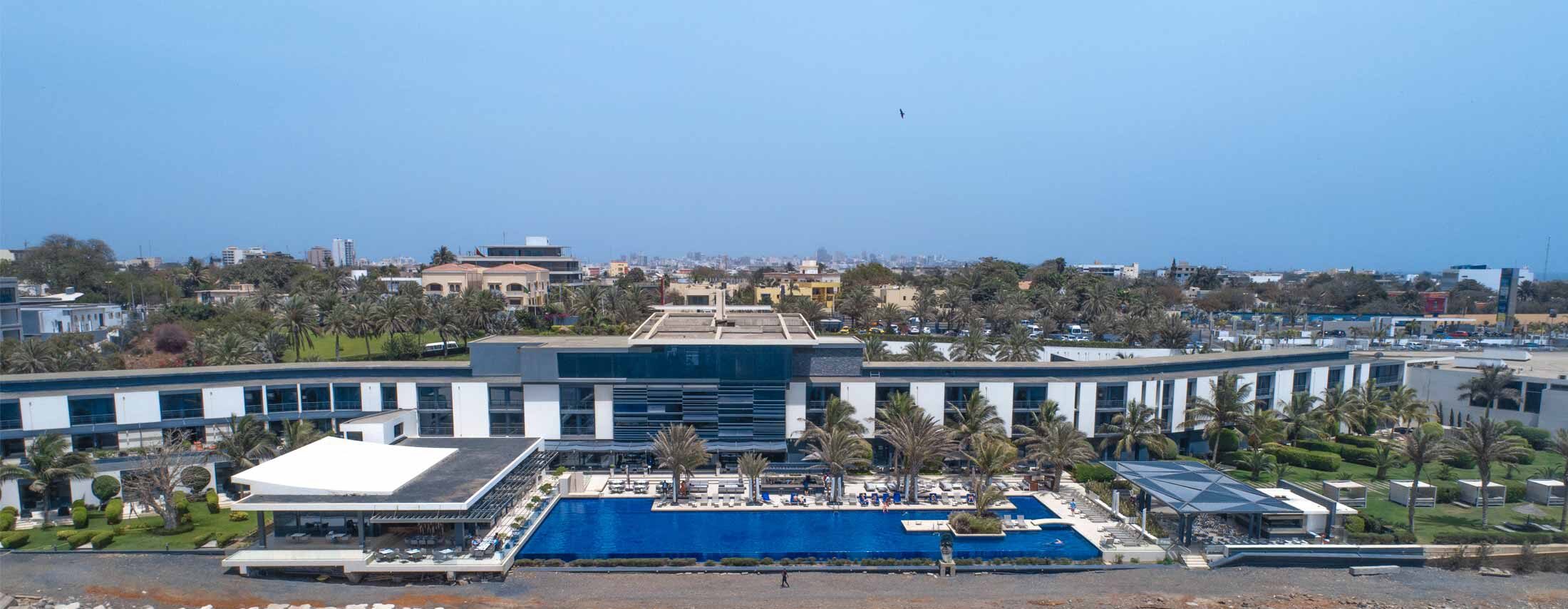 a large building with a large pool in front of it