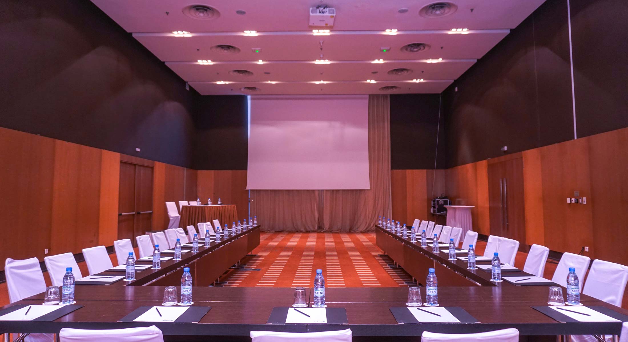 a conference room with tables and chairs set up for a meeting