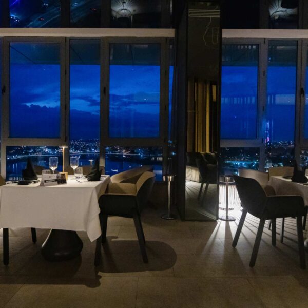 a restaurant with a view of the city at night