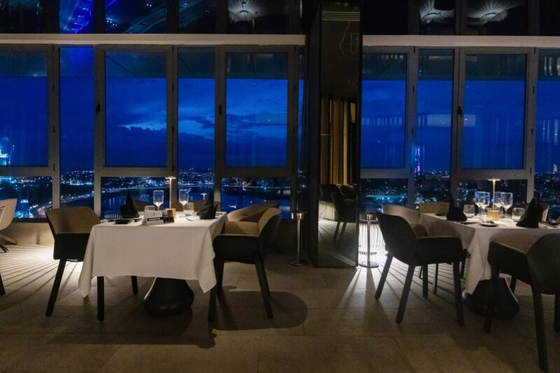 a restaurant with a view of the city at night