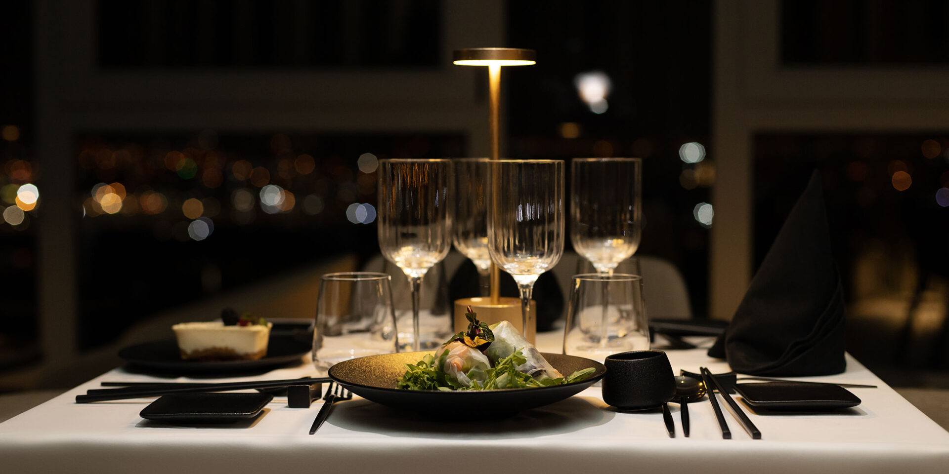 a table with a plate of food and glasses on it