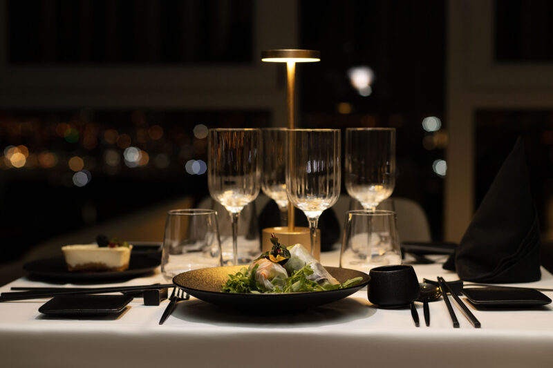 a table with a plate of food and glasses on it