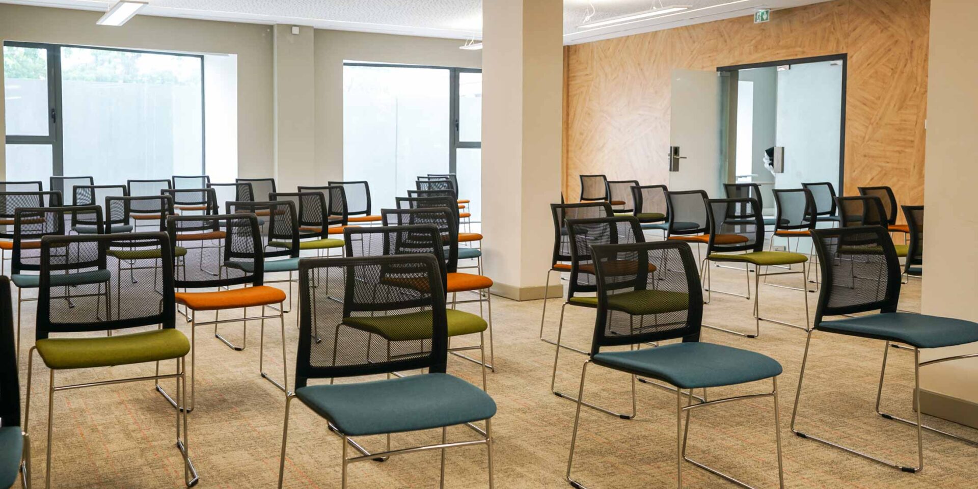 rows of chairs are lined up in a conference room