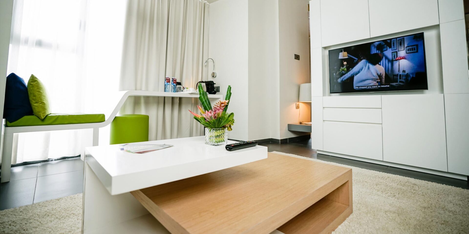 a living room with a flat screen tv and a coffee table