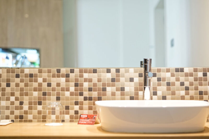 a bathroom with a sink and a sign that says aqua