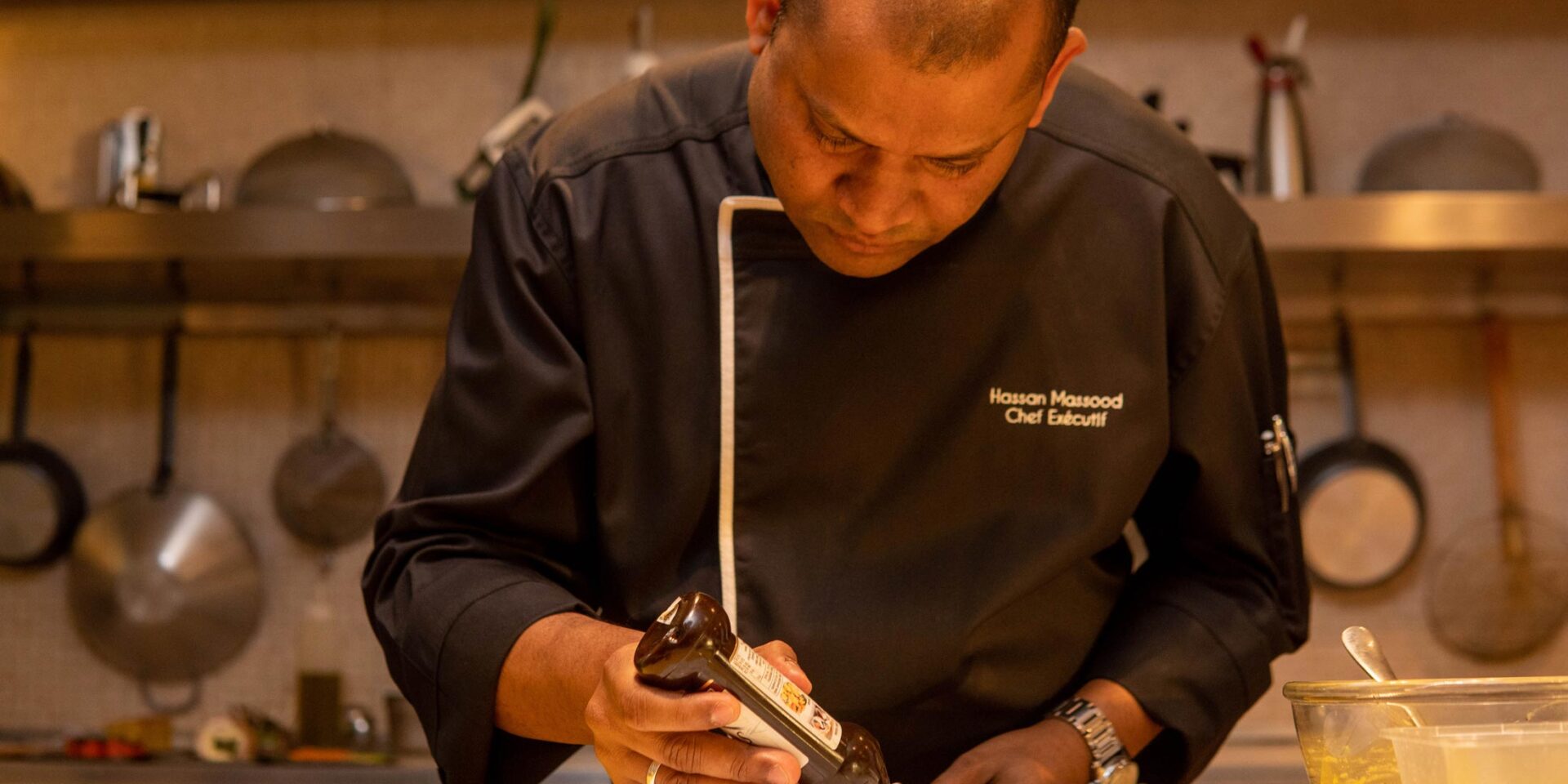 a man in a chef 's jacket is preparing food