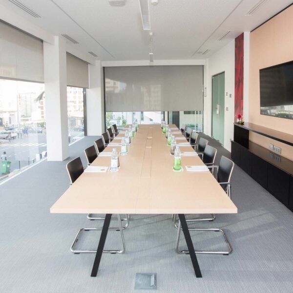 a conference room with a long table and chairs