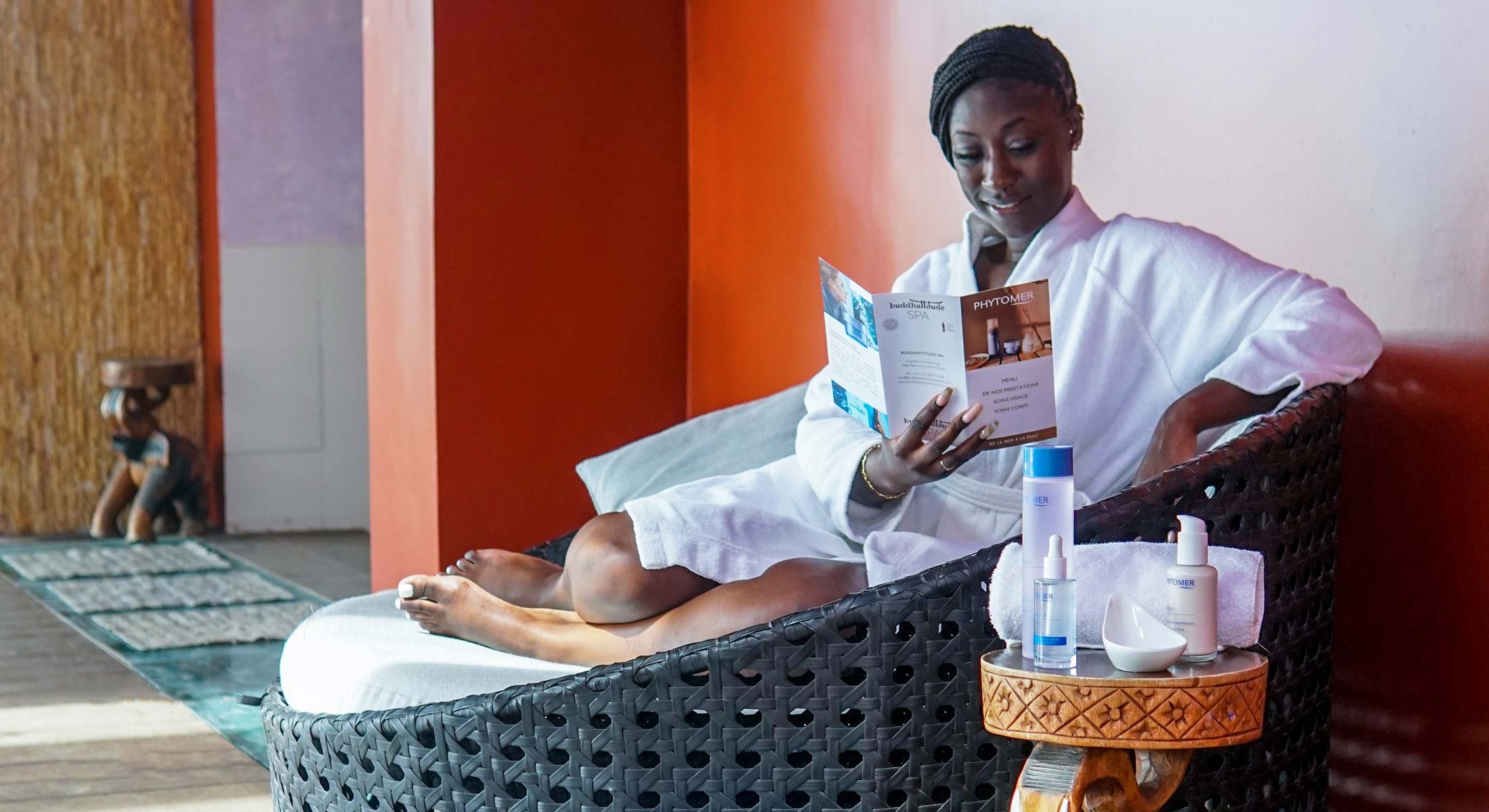 a woman sits in a chair reading a pamphlet for neutrogena