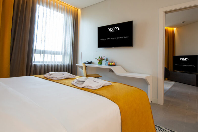 a hotel room with a tv that says naom on it