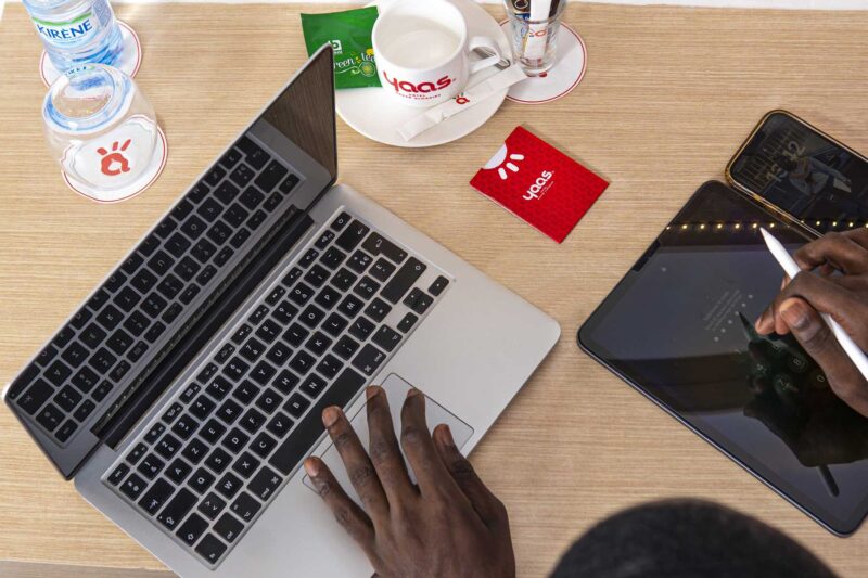 a person using a laptop next to a card that says 