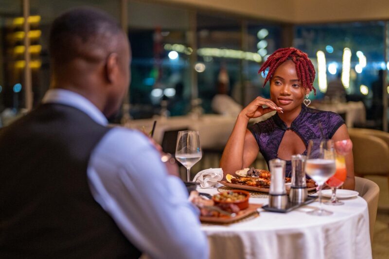 a man and a woman sit at a table in a restaurant