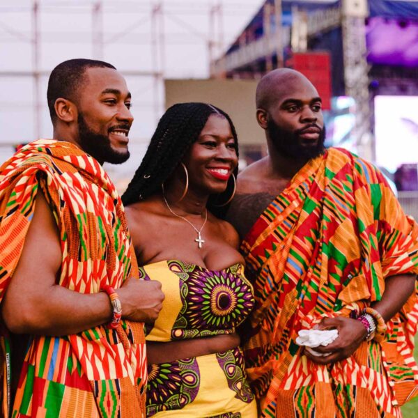 two men and a woman are posing for a picture together