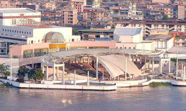 an aerial view of a large building next to a body of water