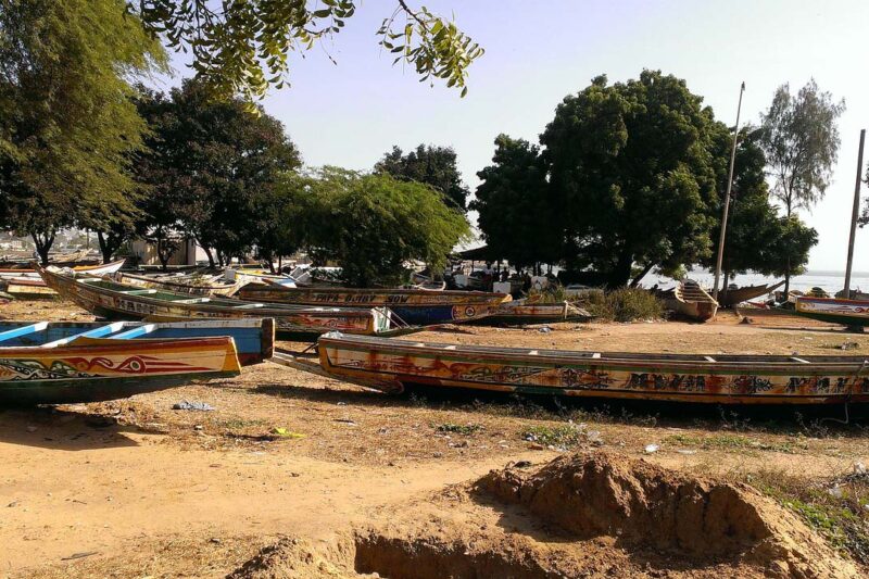 a bunch of colorful boats are lined up on the ground